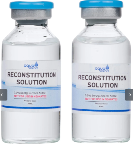 Two 30mL glass vials of Reconstitution Solution with blue caps and white labels, shown side-by-side on a white background. bacteriostatic water
